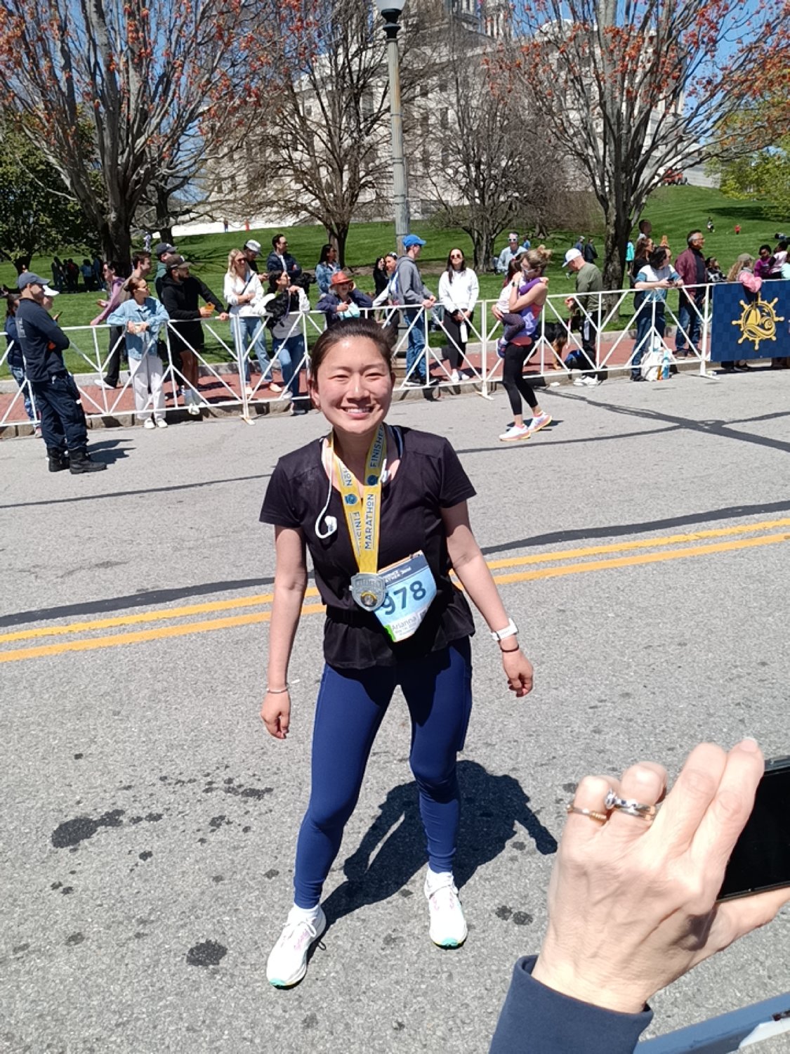 Arianna Kessler smiles after just crossing the Providence Marathon finish line on May 1.